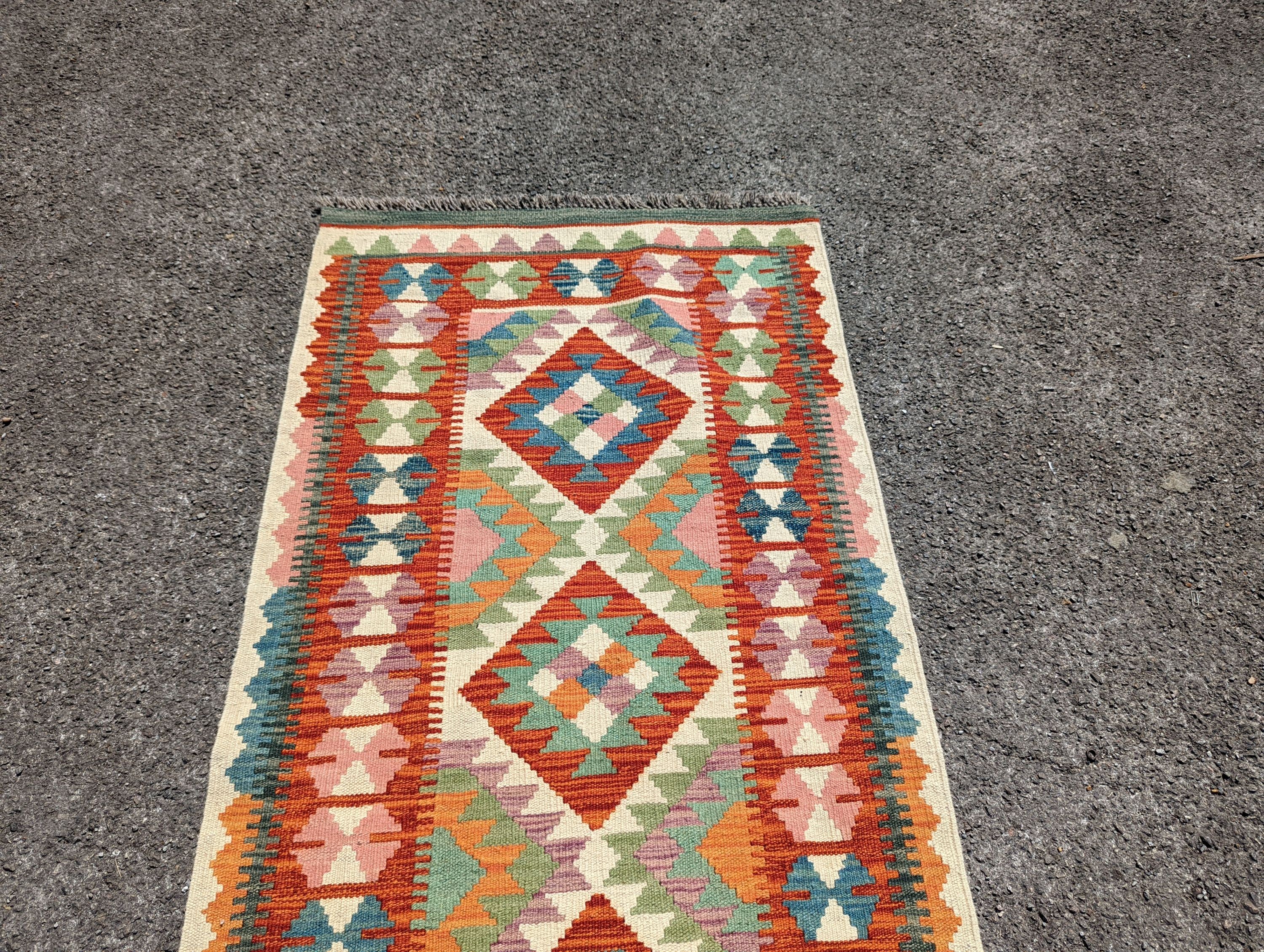 An Anatolian polychrome geometric flatweave Kilim runner, 290 x 84cm